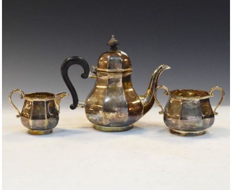 George V three piece silver tea service of Queen Anne style and octagonal bulbous shape comprising: teapot, two handled sugar