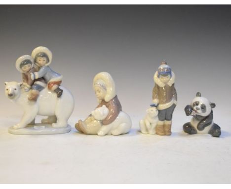 Four Lladro figures comprising: Eskimo Playing, Eskimo Boy With Pet, Eskimo Riders and A Cheerful Panda   Condition: 