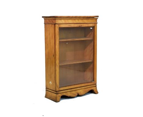 Late 19th century satinwood cabinet bookcase, the top opening to reveal a box interior, glazed door below enclosing three she