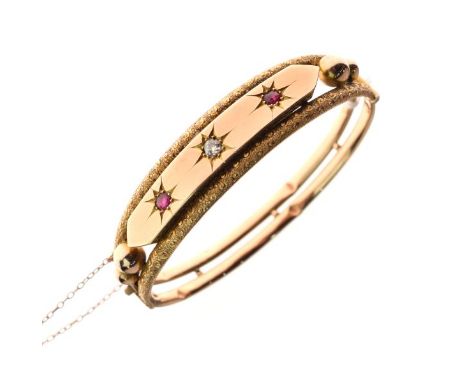 Antique yellow metal hinged bangle set with diamond and ruby coloured stones, stamped 9ct, 12.4g gross approx   Condition: 