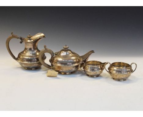 George V silver four piece tea service comprising: teapot, hot water jug, two handled sugar basin and milk, each of compresse