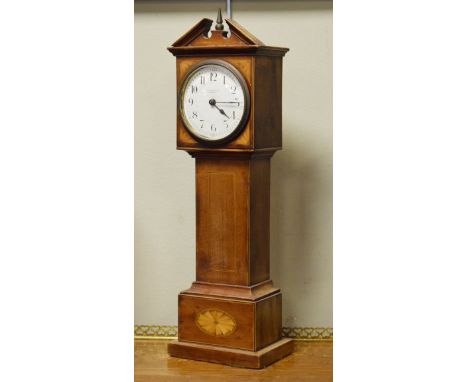 Early 20th Century inlaid mahogany cased mantel clock in the form of a longcase clock, the off-white enamel dial with Arabic 