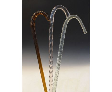 Nailsea type pale green glass walking stick, an amber glass walking stick and a pale amethyst glass walking stick   Condition