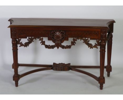 GEORGIAN STYLE CARVED REDWOOD SIDE TABLE, the shaped  oblong top above a carved frieze with central shelf motif and floral sw