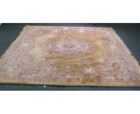 WASHED CHINESE EMBOSSED CARPET of Aubusson design, having gold ground, fawn and brown floral oval centre medallion, borders a