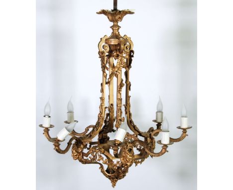 EARLY TWENTIETH CENTURY GILT METAL EIGHT LIGHT ELECTROLIER, the openwork frame with four ribbon tied and down swept arms to a