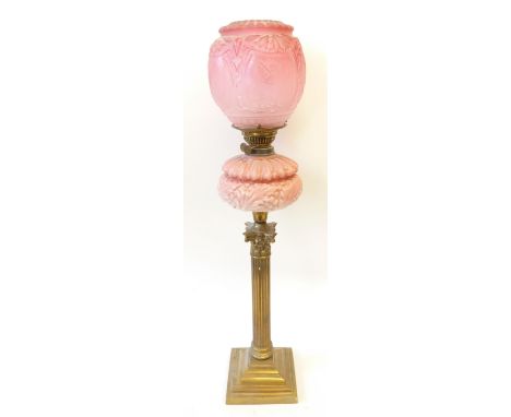 VICTORIAN BRASS TABLE LAMP, with moulded pink glass reservoir and etched pink glass shade, raised above a Corinthian column, 