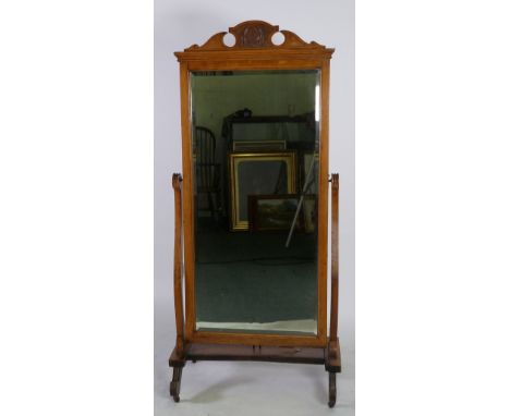 LATE VICTORIAN LIGHT OAK AND EBONISED CHEVAL MIRROR, the oblong, bevel edged plate in a moulded frame with scroll carved cres
