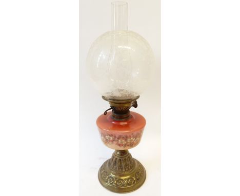VICTORIAN BRASS AND GLASS OIL LAMP, with pink glass and floral enamel decorated reservoir on stepped embossed brass circular 