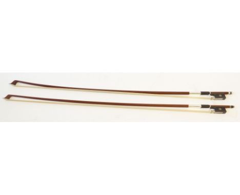 TWO MODERN STUDENTS VIOLIN BOWS, each with octagonal stick, leather and silver wire bound grip, plated metal mounted and moth