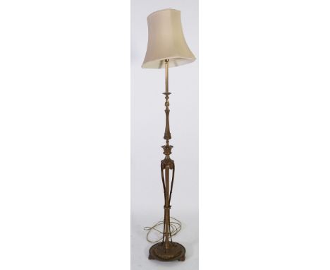 EARLY TWENTIETH CENTURY GILT METAL STANDARD LAMP, with ornately cast column and raised on a moulded circular base, and the cr