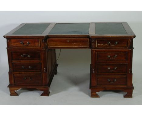 GEORGIAN STYLE CARVED REDWOOD PARTNERS DESK, the rounded oblong top with three green faux leather inserts, above six moulded 