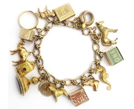 9ct gold fancy link charm bracelet with 22ct gold ring and 9ct gold charms including camera, first aid box, seal etc Conditio
