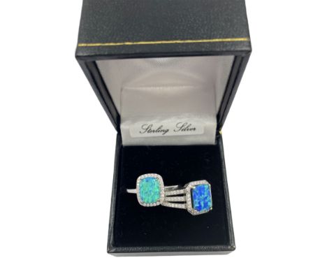 Two silver opal and cubic zirconia cluster rings, stamped or hallmarked, in one box