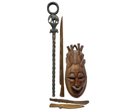 Carved wooden tribal mask, together with a carved wooden walking stick with loop handle and elephant and lion mask decoration