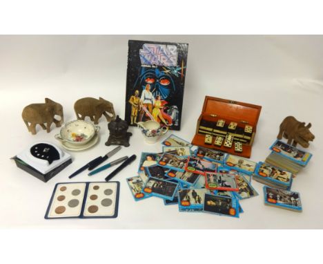 Mixed lot including a boxed set of dominoes, wood carvings, Star Wars movie cards, novelty bell, Star Wars album, some founta