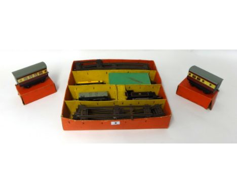A Hornby O gauge and clockwork tinplate train set partly boxed