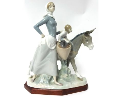 A large Lladro figure, 'Mother child and Donkey' on stand , 37cm