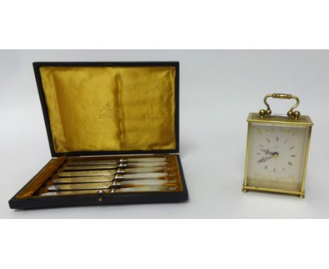 A modern brass cased carriage clock also a cased set of mother of pearl handle cake knives in Mappin & Webb case