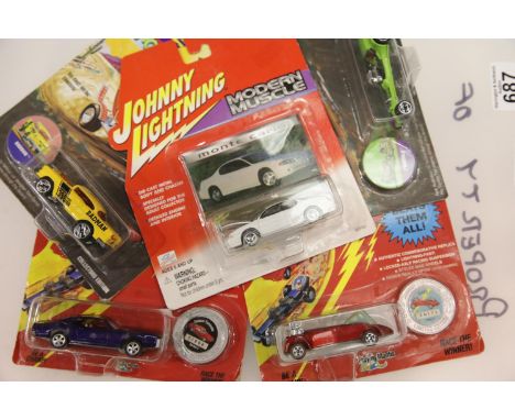 Five Johnny Lightning diecast vehicles: Wacky Winners T'Rantula, Modern Muscle Monte Carlo, Challengers Wasp and Tornado, Wac