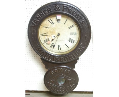 A late 19th century American lacquered wood circular drop trunk wall clock by The Baird Clock Company, Plattsburgh, New York,