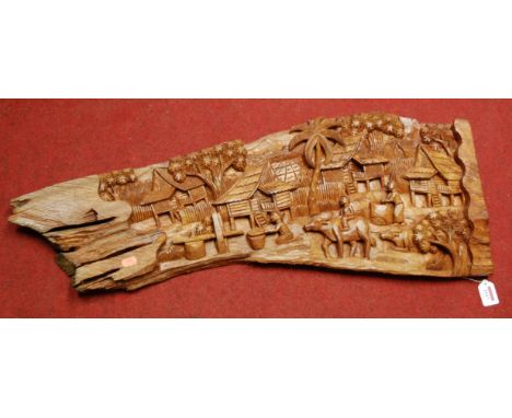 An Eastern relief carved hardwood wall panel 