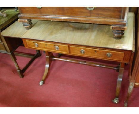 A Regency mahogany and satinwood strung dropflap sofa table, having twin frieze drawers and raised on outswept supports to tu