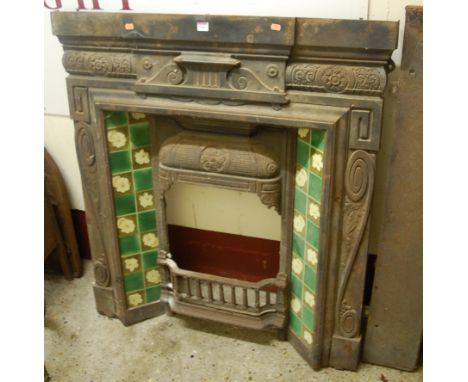 A late Victorian cast metal and tiled inset fire surround