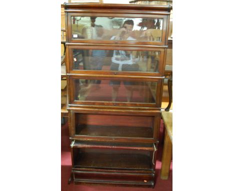 A 1930s Globe Wernicke walnut five tier stacking bookcase, having typical hinged glazed doors (one lacking glazing panel, ano