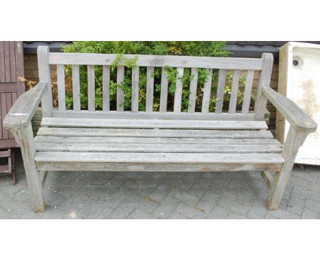 A slatted teak three-seater garden bench