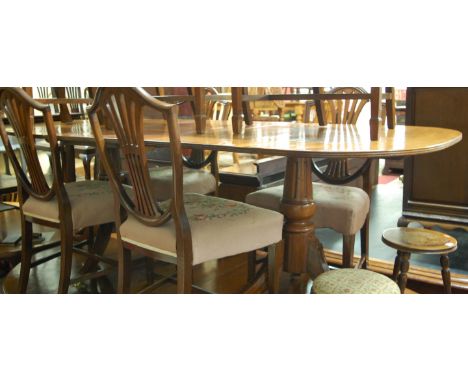 A Regency style mahogany twin pedestal dining table, having single extra drop-in leaf, together with a set of eight Hepplewhi