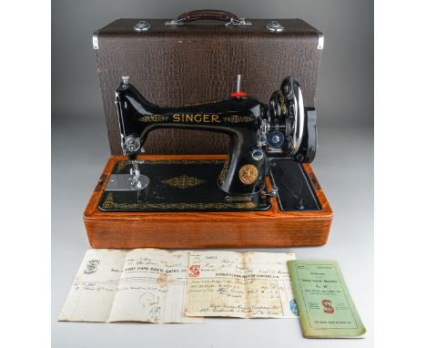 A cased Singer manual sewing machine, serial number EC561247, circa 1939, the case fitted with oil can, case of accessories, 