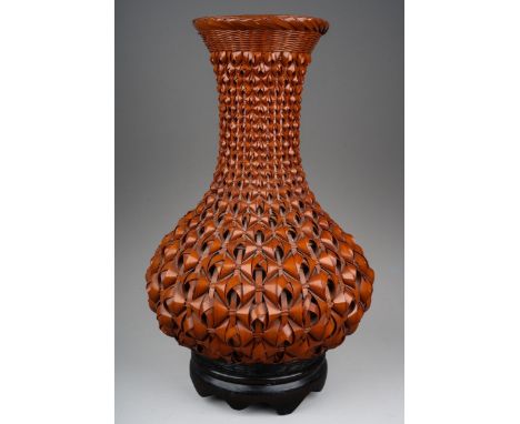 A modern Japanese Ikebana style woven wicker vase with ceramic liner and fitted wooden stand, height 33cm
