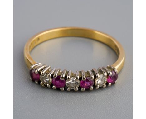An 18ct gold diamond and ruby ring. Set with alternating rubies and diamonds, hallmarked 18ct gold, gross weight 2.1 grams.