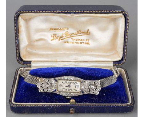 An early 20th century diamond cocktail watch. the cream dial, with black Arabic numerals, within an diamond set surround with