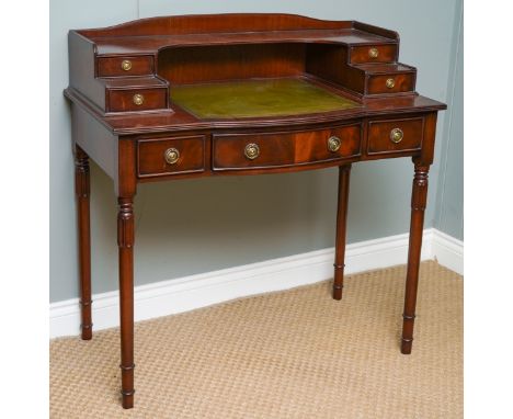 A reproduction mahogany finish Carlton House style writing desk, the raised stepped back with shelf, fitted with four drawers