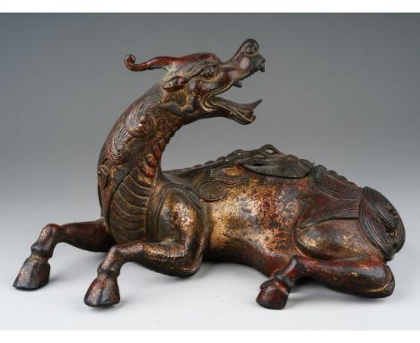 A Japanese cast bronze koro in the form of a reclining Kirin, pierced cover, unsigned, height 16cm x length 26cm