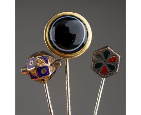 A collection of three late Victorian stickpins, to include a yellow metal blue enamel faceted spherical design stickpin, a ye