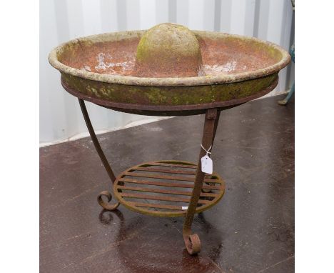 A cast iron circular Mexican hat pig trough, fitted on a separate circular base, diameter 70cm x height to brim 55cm