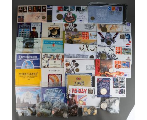 A collection of British and World coins and stamps in packs and loose, including seven United Kingdom Uncirculated Coin Colle