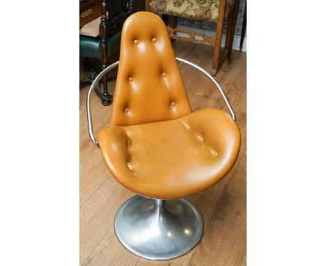 A mid 20th century chrome and tan leather effect button back atomic style swivel chair, chrome arms, cylindrical pedestal to 