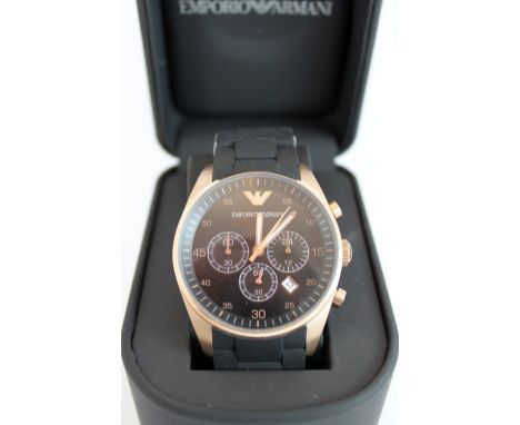 New boxed Emporio Armani chronograph wristwatch with multi-dial black face with a rose gold surround on a black rubber strap.