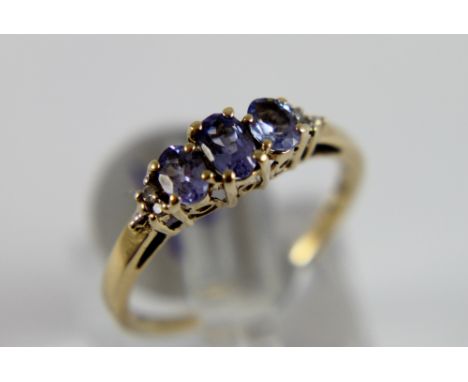 9 ct gold tanzanite and diamond three stone set ring, size K