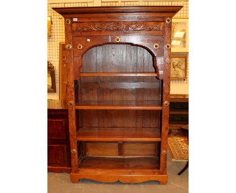 Four shelf bookcases in stained pine with detailed carving and brass rosettes