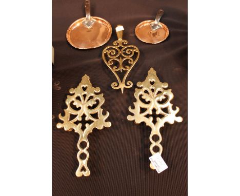 Three decorative brass kettle stands and two copper pan lids 