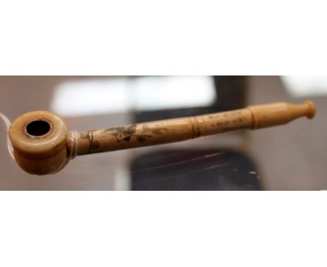 A carved bone Chinese smoking pipe decorated with birds and flowers