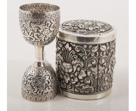 Indian white metal caddy box, repoussed with lotus floral motifs, cylindrical form, stamped 800s, 835cm high; and a similar d
