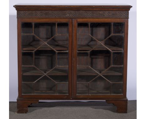 Mahogany dwarf bookcase, rectangular top with rounded corners and moulded edge, blind fretwork frieze, astragal glazed doors 