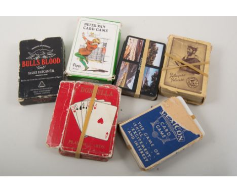 Two albums of postcards, topographical, comic, greetings, collection of playing cards.