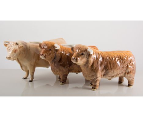 Beswick pottery models,  two Highland Bulls, model.2008, 12cm tall; Charolais Bull, 2463A, all with damages, (3).